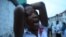 A supporter of the opposition Sierra Leone People's Party party cries outside a party office after candidate Julius Maada Bio lost last week's presidential election, Freetown, Sierra Leone, Nov. 23, 2012.