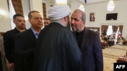 Iraqis offer their condolences to Iranian Ambassador Muhammad Kazem al-Sadiq, right, for the death of the Islamic republic's late president Ebrahim Raisi during a service on May 20, 2024 for the president and his entourage, who were killed in a helicopter crash.