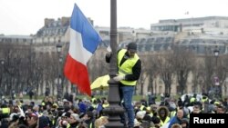 Protesters wearing yellow vests take part in a demonstration in Paris, Jan. 19, 2019.