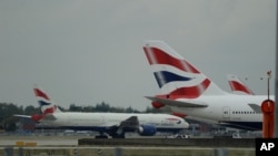 FILE - British Airways planes are seen parked at Heathrow Airport in London, Sept. 9, 2019. 