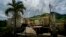 FILE - In this Sept. 8, 2018 file photo, a home that was abandoned after Hurricane Maria hit one year ago stands full of furniture in the San Lorenzo neighborhood of Morovis, Puerto Rico.