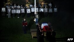 FILE - French army soldiers carry the coffin of Missak Manouchian, a hero of the French Resistance in World War II of Armenian origin who was executed by occupying Nazi forces in 1944, during a vigil ceremony at the Mont Valerien in Suresnes, west of Paris, on February 20, 2024.