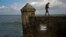 A fisherman walks along the sea wall of Havana, Jan. 13, 2017. The U.S. disclosed that the attacks on the health of American diplomats in Havana continued as recently as August. The number of foreign service personnel affected was raised to 19.