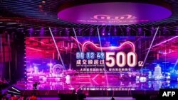 A screen shows the gross merchandise volume, a measure of sales, after 12 minutes 49 seconds of Singles Day sales, as it reaches about 7,147,554,107 USD in Hangzhou in China's eastern Zhejiang province early on November 11, 2019. 