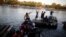 People belonging to a caravan of migrants from Honduras en route to the United States, cross the Suchiate river to Mexico from Tecun Uman, Guatemala, Jan. 18, 2019. 