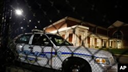 Huffman High School is seen behind a Birmingham police car after a shooting March 7, 2018, in Birmingham, Ala.