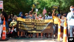 Protesters march for voting rights at the Texas Capitol in Austin, Texas, July 31, 2021.