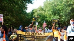 Protesters march for voting rights at the Texas Capitol in Austin, Texas, July 31, 2021.