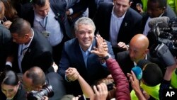 FILE - Ivan Duque, candidate of the Democratic Center party, greets supporters after voting during a presidential election in Bogota, Colombia, June 17, 2018.