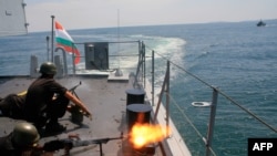 Bulgarian marines fire machine guns on board a Bulgarian navy frigate ship during Bulgarian hosted NATO drills. 