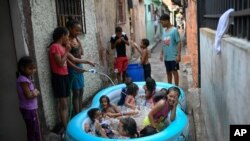 Children play in an inflatable pool during carnival in the Pinto Salinas neighborhood of Caracas, Venezuela, Feb. 15, 2021, amid the coronavirus pandemic.