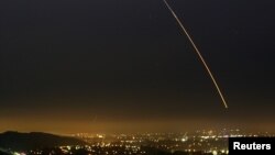 FILE - An unarmed Minuteman intercontinental ballistic missile streaks through the sky during a test launch, over Vandenberg Air Force Base in California Aug. 25, 2005.