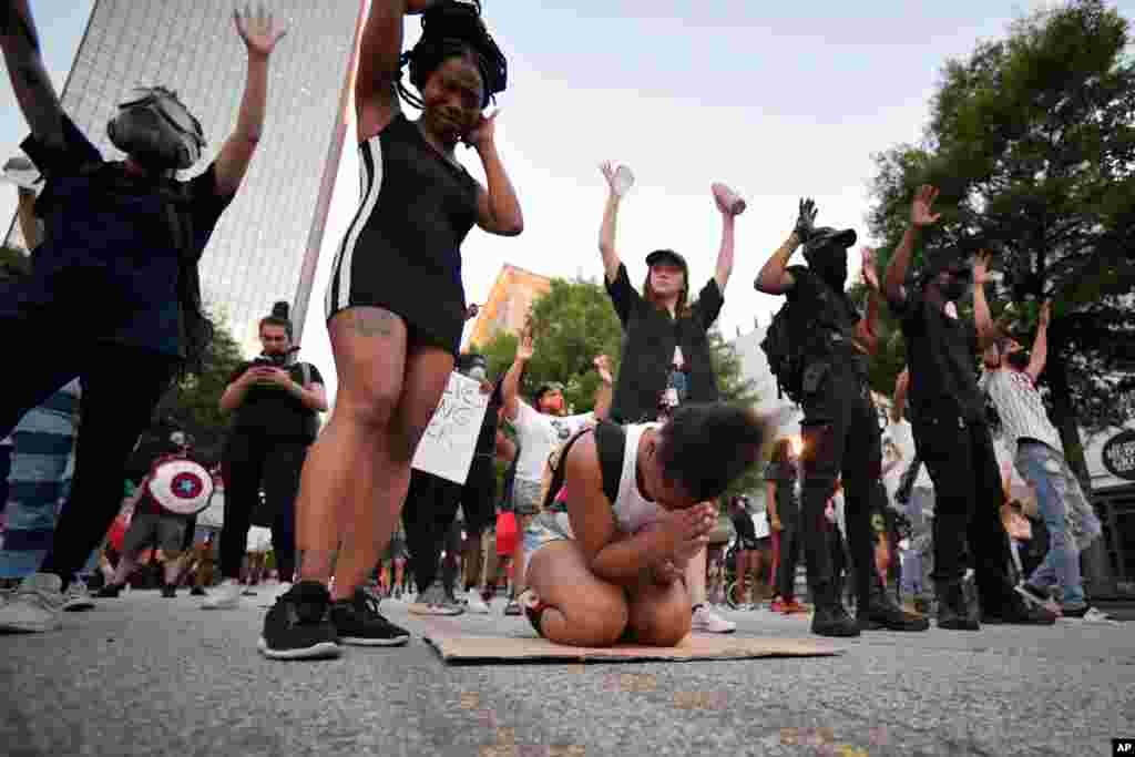 Demonstrators pray during a march, Sunday, May 31, 2020, in Atlanta.