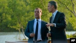 Norwegian Prime Minister Jens Stoltenberg (R) speaks to his Russian counterpart Dmitry Medvedev as a part of the Barents Summit 2013 in Kirkenes, Norway, June 3, 2013.