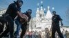 RUSSIA -- Russian police officers detain a protester during an unauthorized anti-Putin rally called by opposition leader Alexei Navalny on May 5, 2018 in Moscow, two days ahead of Vladimir Putin's inauguration for a fourth Kremlin term.