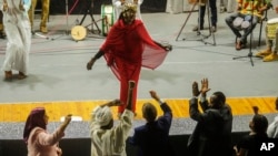 Sudanese Camirata troupe dancer Hoda Othman, performs a dance from Central Sudan, "Al-Arda," at the Russian culture center in Cairo, Sept. 15, 2024.