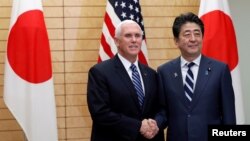 U.S. Vice President Mike Pence shakes hands with Japanese Prime Minister Shinzo Abe at Abe’s official residence in Tokyo, Japan.