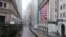 FILE - The normally busy area of Wall Street at the New York Stock Exchange is empty on a rainy day in New York, April 13, 2020. 