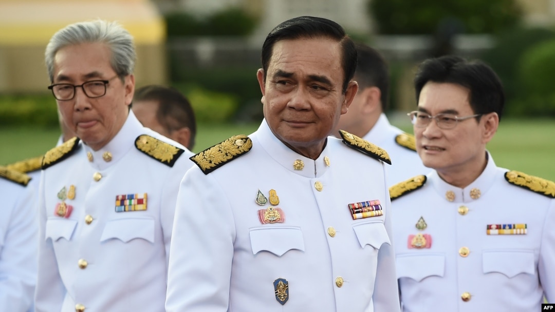 Thailand's Prime Minister Prayuth Chan-ocha, center, arrives for a photo opportunity with members of the new Thai cabinet at Government House in Bangkok, July 16, 2019. 