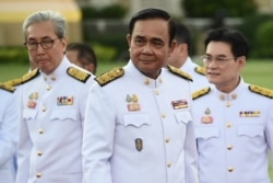 Thailand's Prime Minister Prayuth Chan-ocha, center, arrives for a photo opportunity with members of the new Thai cabinet at Government House in Bangkok, July 16, 2019.