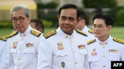 Thailand's Prime Minister Prayuth Chan-ocha, center, arrives for a photo opportunity with members of the new Thai cabinet at Government House in Bangkok, July 16, 2019. 