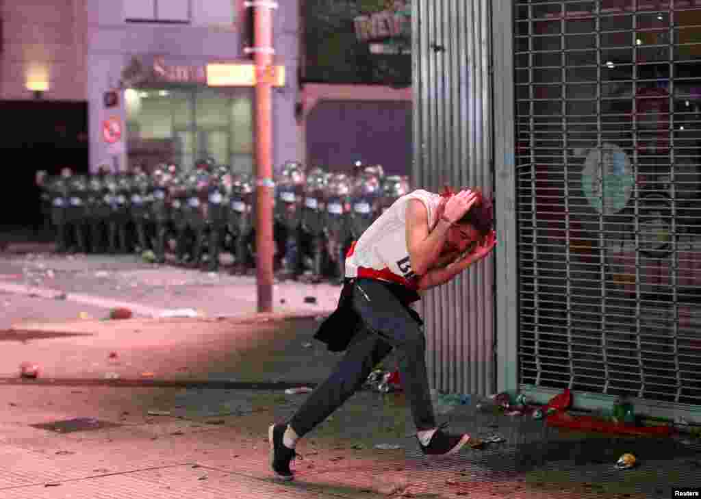 Riot police clash with River Plate fans in Buenos Aires, Argentina. Dec. 9, 2018, after the team won the all-Argentine Copa Libertadores final against Boca Juniors at the Santiago Bernabeu stadium in Madrid, Spain.