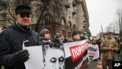 Supporters of the Movement of New Forces, the political party led by Mikheil Saakashvili, march to call for Ukraine's President Poroshenko to resign in central Kyiv, Dec. 17, 2017.