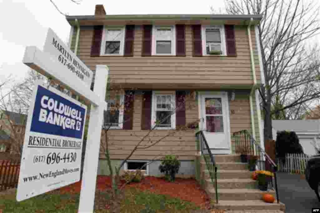 In this Nov. 16, 2011 photo, a real estate sign hangs in front of a home, in Milton, Mass. Existing-home sales improved in October while the number of homes on the market continued to decline, according to the National Association of Realtors(R). (AP Phot