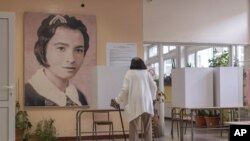 A woman is seen at a polling station during parliamentary election in Belgrade, Serbia, June 21, 2020. 