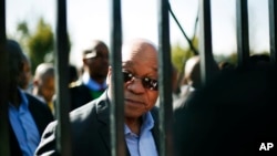 FILE - South African President Jacob Zuma speaks to school children before a political rally of the African National Congress in the Soweto township in Johannesburg, on June 14, 2013. 