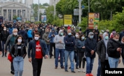 FILE - Opposition supporters wearing protective masks amid the coronavirus disease outbreak wait in a line to put signatures in support of their potential candidates in the upcoming presidential election in Minsk, Belarus, May 31, 2020.