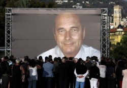 People gather to pay tribute to the late former French President Jacques Chirac in Nice, France, Sept. 27, 2019.