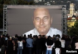 People gather to pay tribute to the late former French President Jacques Chirac in Nice, France, Sept. 27, 2019.