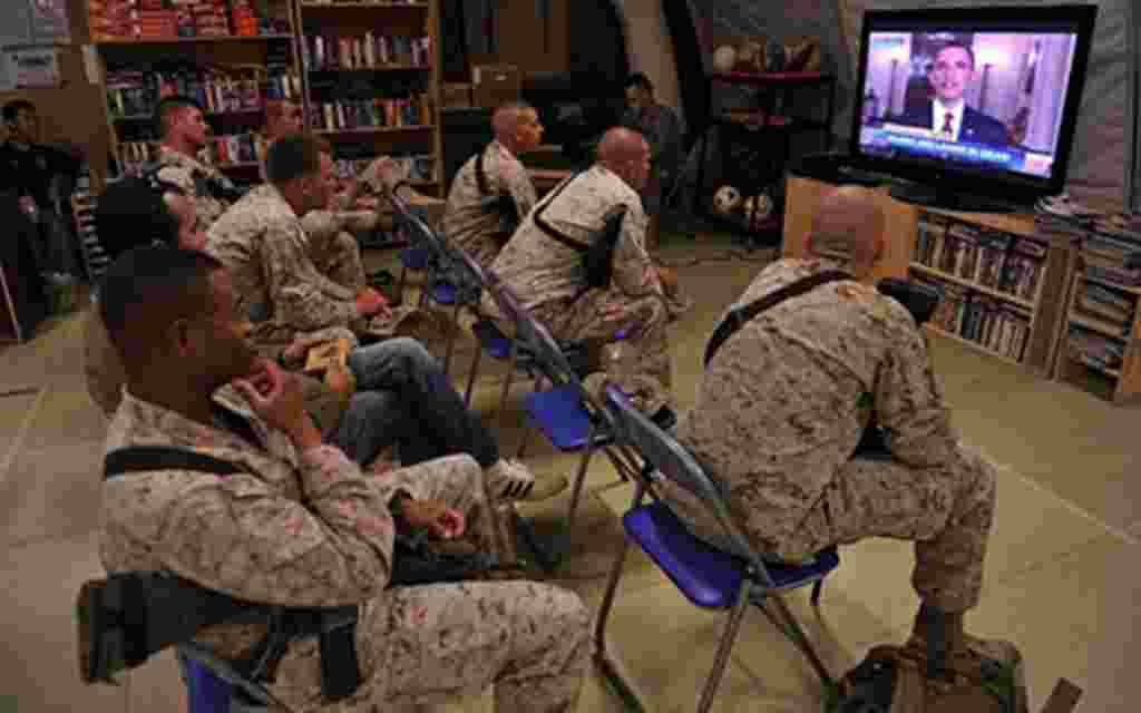 US Marines of Regiment Combat Team 1 (RCT 1) watch TV as President Barack Obama announces the death of Osama Bin Laden, at Camp Dwyer in Helman Province, on May 2, 2011. US President Barack Obama said on May 1, 2011 that justice had been done after the Se