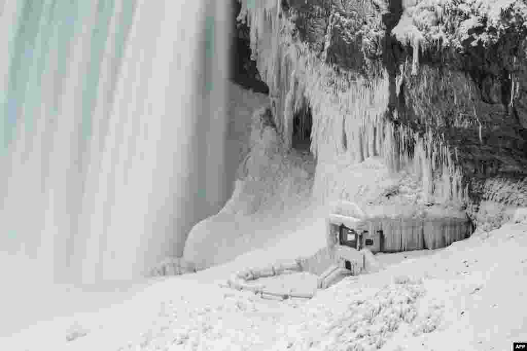 An observation point at the base of Niagara Falls is covered with ice, in Niagara Falls, Ontario, is covered in ice, Jan. 9, 2018. A giant winter &quot;bomb cyclone&quot; walloped the U.S. East Coast on Jan. 5, 2018, with heavy snow and freezing cold that made for treacherous travel conditions and bone-chilling misery.