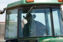 Farmer John Boyd Jr., runs his hay bailer at his farm in Boydton, Va., May 27, 2021.