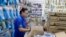 A medical supply store worker organizes masks that customers are buying as a precaution against the spread of the new coronavirus COVID-19, in Sao Paulo, Brazil, Feb. 26, 2020.