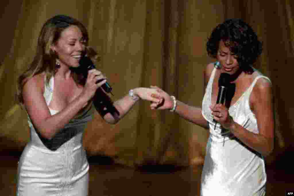 Mariah Carey, left, and Whitney Houston perform their Oscar-nominated song, "When You Believe" from the movie "The Prince of Egypt," during the 71st Annual Academy Awards at the Dorothy Chandler Pavilion of the Los Angeles Music Center Sunday, March 21, 1