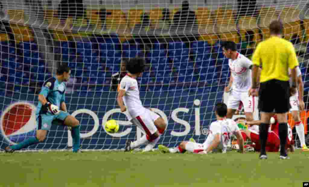 Morocco's Houssine scores against Tunisia during their African Cup of Nations soccer match in Libreville