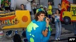 Activists call for leaders to “tear down the pillars of fossil fuels” in front of Brooklyn Borough Hall during a climate demonstration in New York on Sept. 20, 2024.