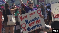 Pro-choice demonstrators wave signs and make their voices heard after the Supreme Court upheld abortion rights in a 5-3 decision, in front of the Supreme Court building in Washington, June 27, 2016. (J. Oni / VOA News)