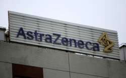 FILE - The AstraZeneca logo is shown on the company's building in Shanghai, China.