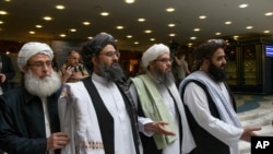 FILE - In this May 28, 2019 file photo, Mullah Abdul Ghani Baradar, the Taliban group's top political leader, second left, arrives with other members of the Taliban delegation for talks in Moscow, Russia.