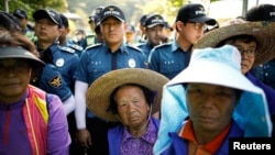 Villagers are blocked by South Korean policemen as they march during an anti-THAAD protest near an entrance of a golf course where a Terminal High Altitude Area Defense (THAAD) system is deployed, in Seongju, South Korea, June 14, 2017. 