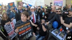 Sue Krupa and about 1,000 Mormons and former Mormons march to the church's headquarters in Salt Lake City, March 30, 2018, to deliver petitions demanding an end to one-on-one interviews between Mormon youth and lay leaders and the sexual questions that sometimes arise during the meetings.