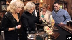 FILE - In this Thursday, Feb. 4, 2010 file photo, the Duchess of Cornwall, second left, pulls a pint of beer in the Rovers Return pub, as she meets actors Beverley Callard, left, who plays landlady Liz McDonald, Anne Kirkbride, second right, who plays Deirdre Barlow, second right, and Ryan Thomas, who plays Jason Grimshaw, during a visit to the the set of the British television soap opera 'Coronation Street', in Manchester, England. British writer Tony Warren, who created "Coronation Street,'' has died at 79. 