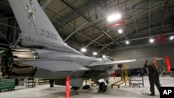 FILE - A U.S. F-16 fighter jet is seen in a hangar in South Burlington, Vermont, Dec. 17, 2012.