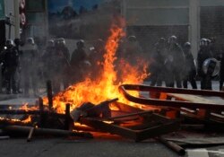 FILE - Police face a burning barricade during protests, Sept. 21, 2019, in Hong Kong.