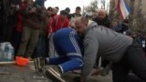 People queue to receive humanitarian aid in the town of Debaltseve, northeast from Donetsk, March 13, 2015.