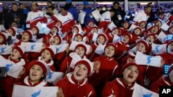 Members of the North Korean delegation hold flags of the combined Koreas before the opening ceremony of the 2018 Winter Olympics in Pyeongchang, South Korea, Feb. 9, 2018.